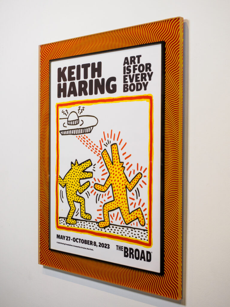 Vibrant colors of a Keith Haring poster seen through Optium Museum Acrylic glazing, custom framing at Underglass Castro San Francisco