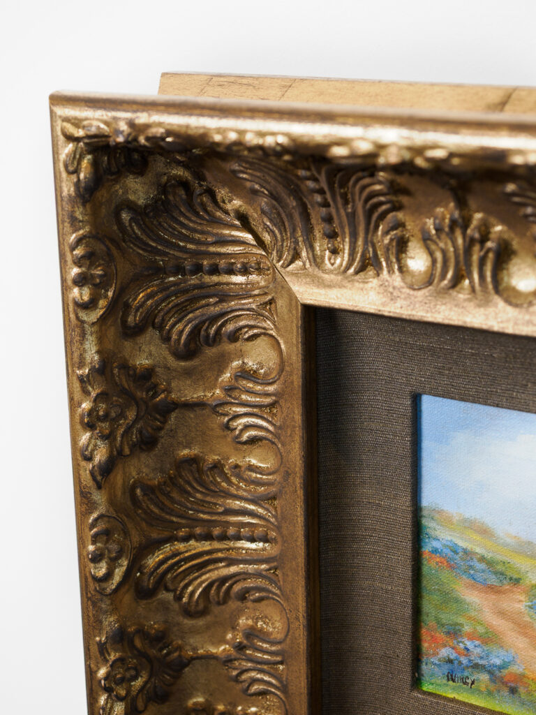 Close-up of ornate gilded frame detail with deep scoop profile, custom picture framing San Francisco