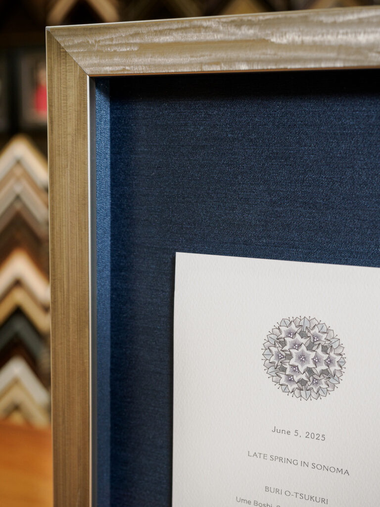 Shadowbox detail showing marine blue silk fabric mat and float mounted tasting menu, custom picture framing Castro San Francisco