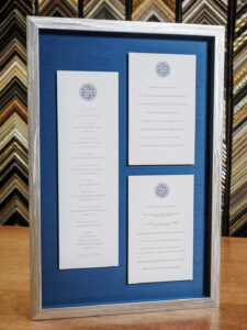 Custom framed SingleThread tasting menu in silver finish wood frame and marine blue silk fabric mat shadowbox, San Francisco frame shop