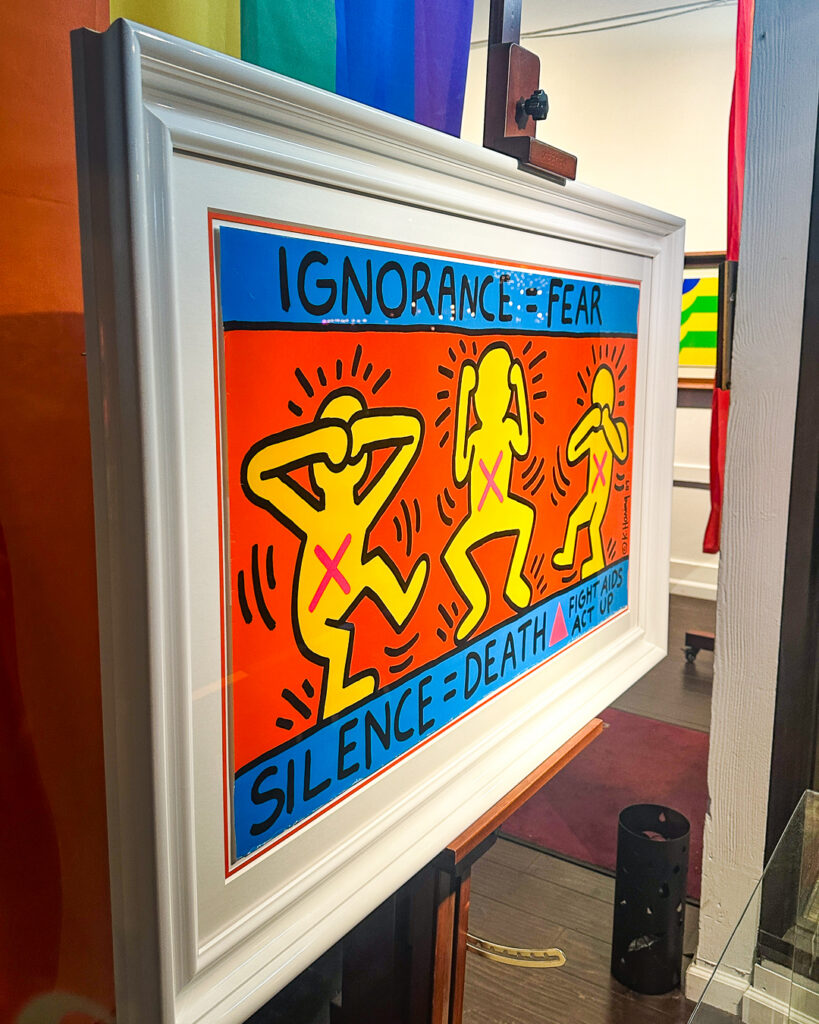 Custom framed Keith Haring Ignorance = Fear poster in lacquer white frame with orange-red double mat, Castro frame shop San Francisco
