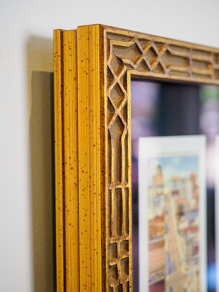 Close-up of float mounted vintage San Francisco cards in grid arrangement on black fabric mat, custom framing Castro San Francisco