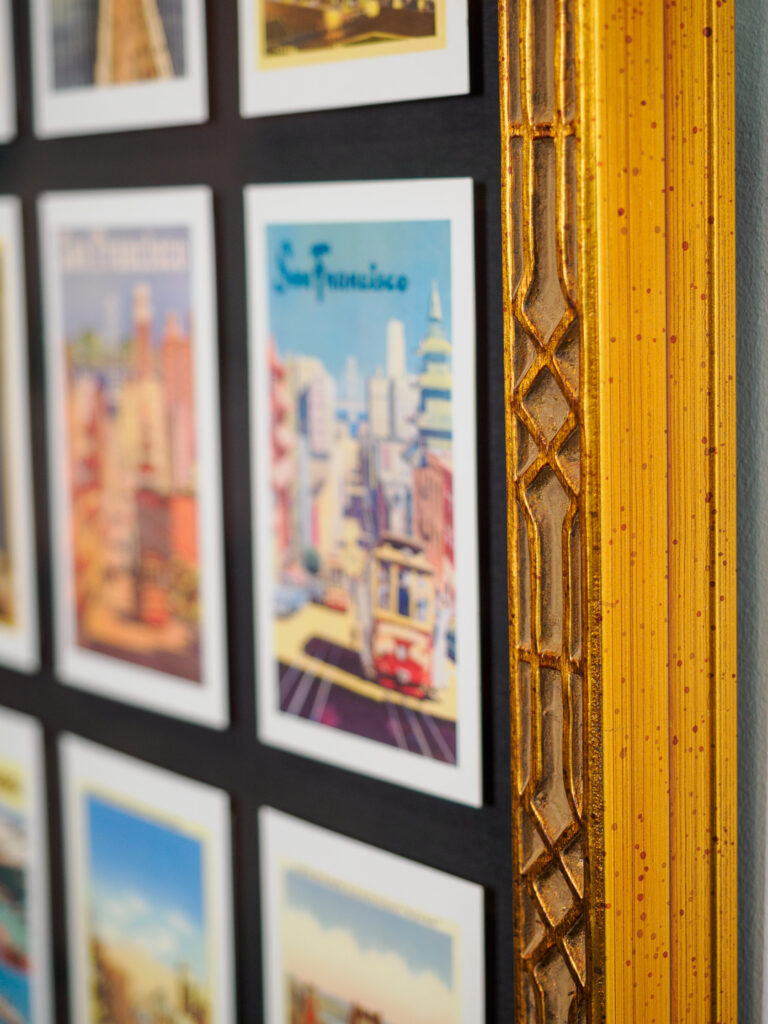 Close-up of float mounted vintage San Francisco cards in grid arrangement on black fabric mat, custom framing Castro San Francisco