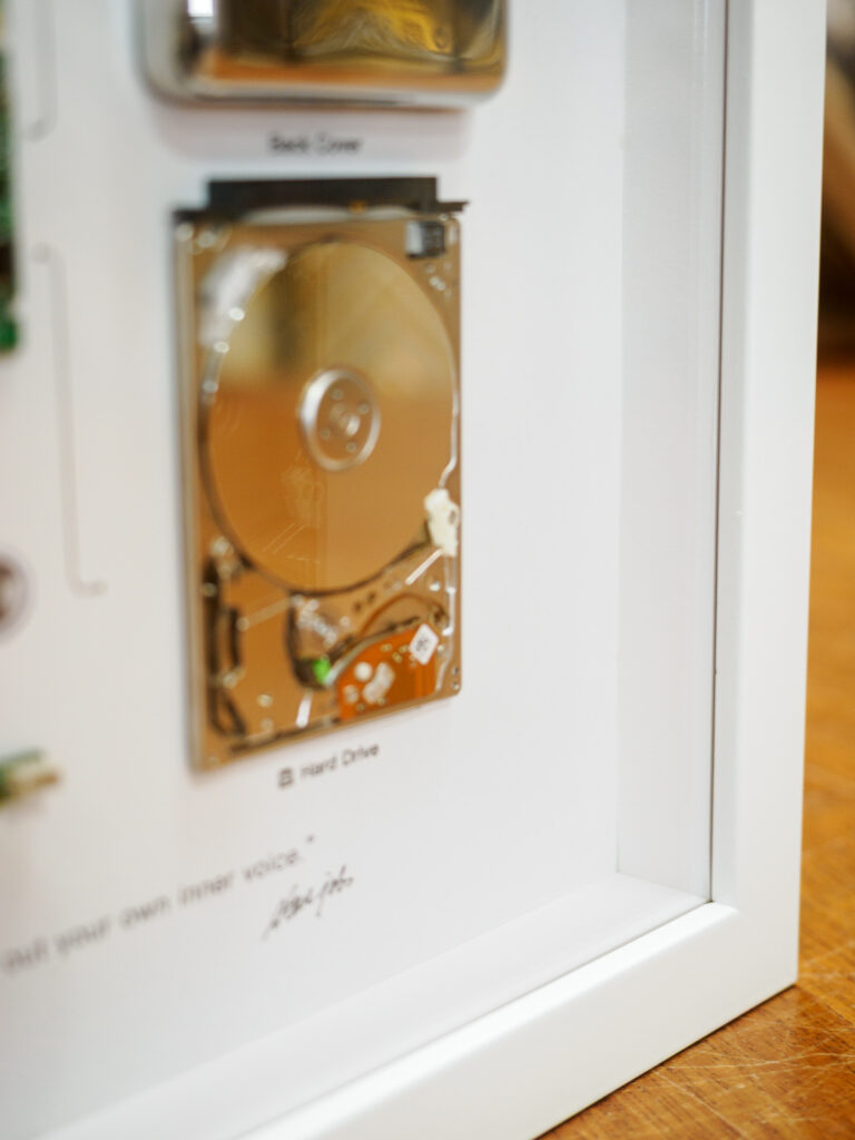 Close-up of disassembled iPod components in white shadowbox, conservation framing San Francisco Underglass
