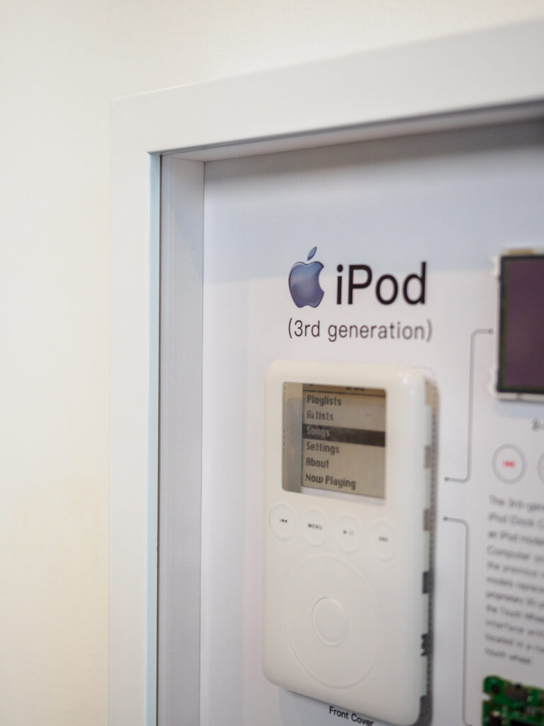 Close-up of disassembled iPod casing in white shadowbox, conservation framing San Francisco Underglass
