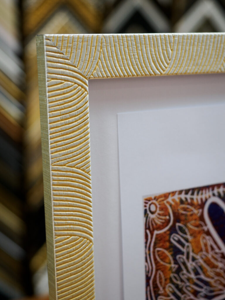 Close-up of float mounted print with shadow line on white mat board, custom picture framing San Francisco Underglass