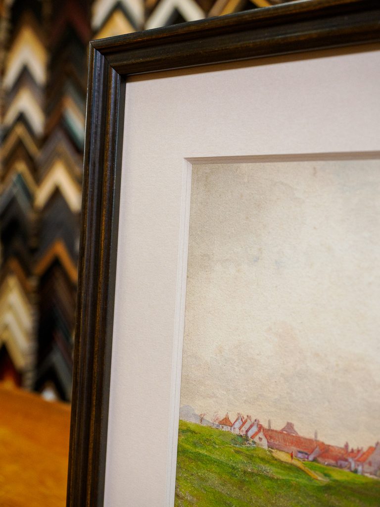 Close-up of thick 8-ply off-white bevel mat on coastal landscape painting, custom picture framing Castro San Francisco